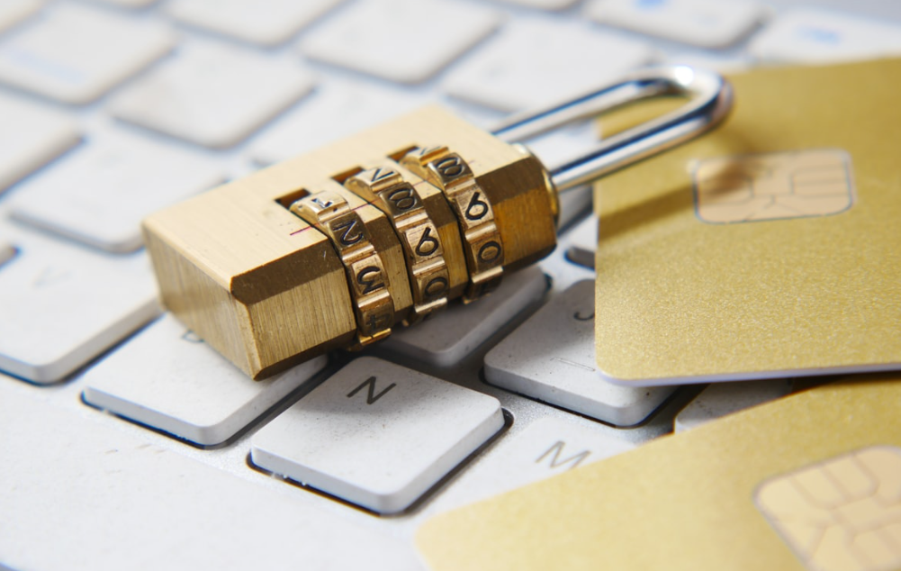 Image of a padlock sat on the keyboard of a Laptop